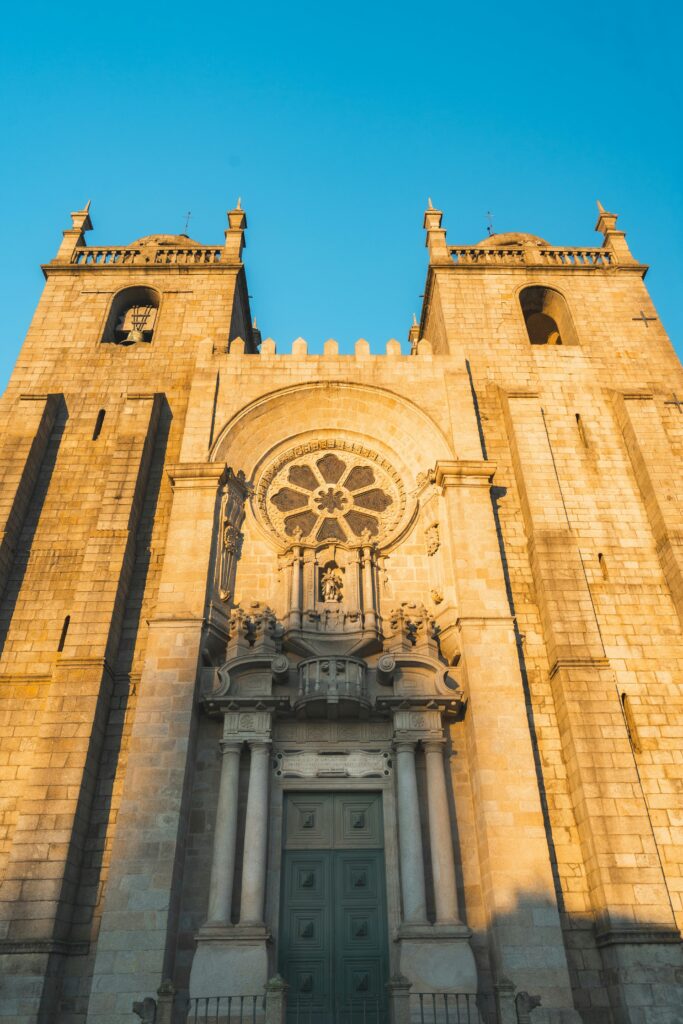 Stunning view of the Porto Cathedral's Gothic facade in warm evening light.