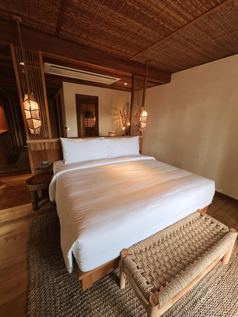 Inviting modern bedroom featuring natural wood decor and comfortable bedding.